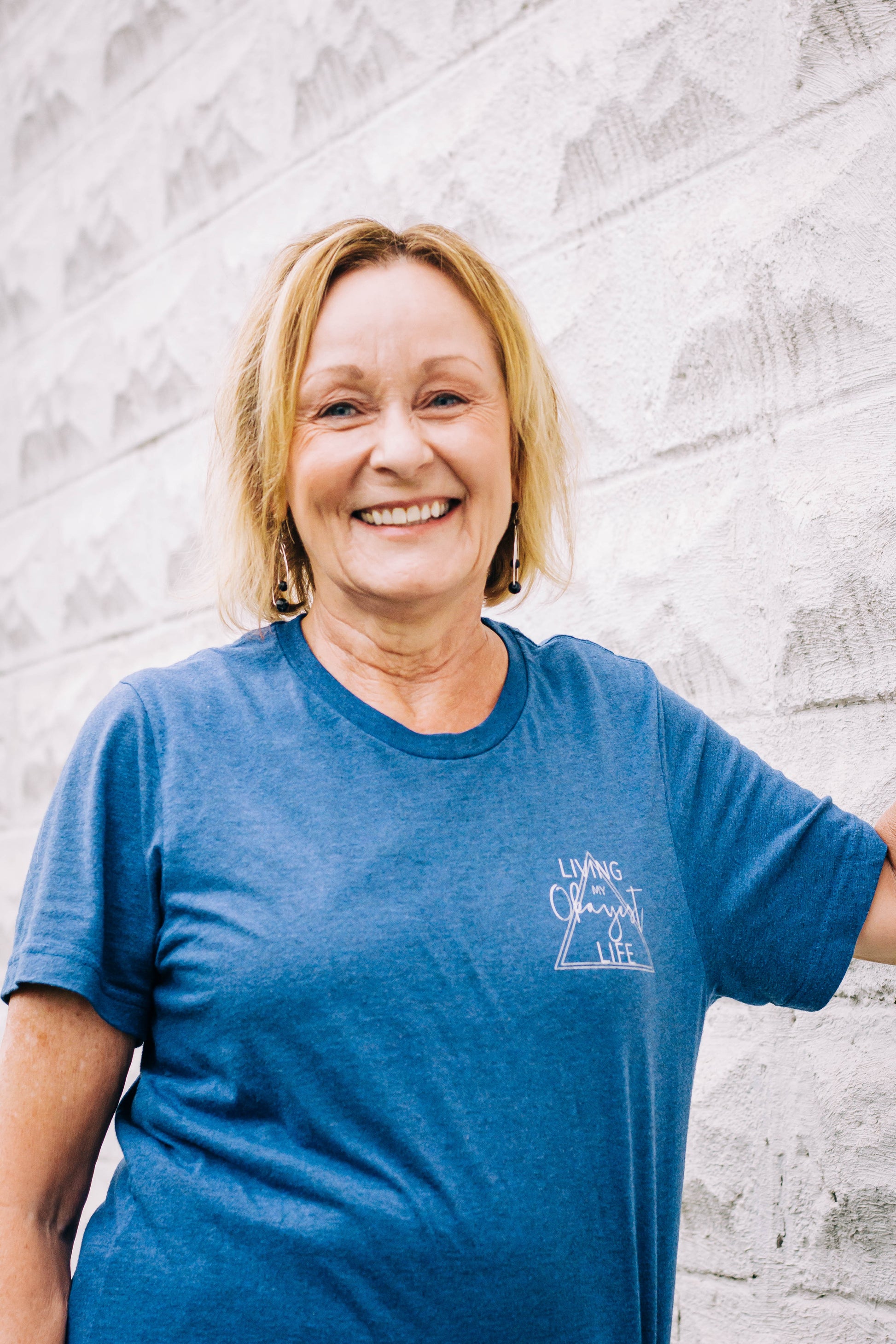 Woman posing with Okayest Life Blue T-shirt